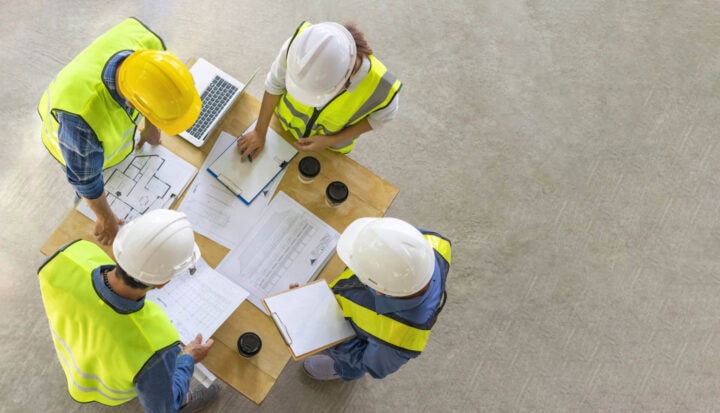 bunch of construction workers looking at charts